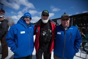 Grizz stands with Chris Coughlin, left, and Scott Harrison, right, 