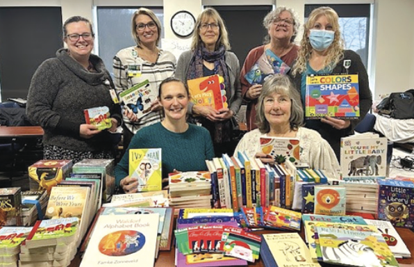 Visiting Nurse and Hospice employees donate and distribute books for youth throughout the community